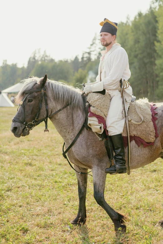 a man riding on the back of a horse in a field, a portrait, unsplash, renaissance, wearing russian ww 1 clothes, gray, camp, profile image