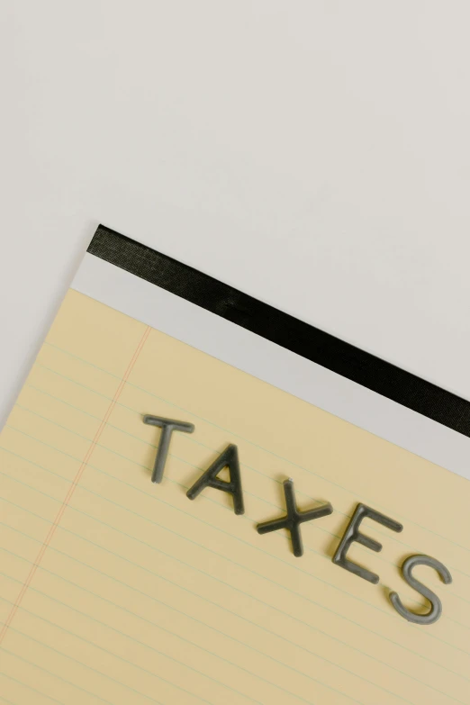 a piece of paper with the word taxes written on it, an album cover, detail shot, detailed product image, staples, hi-res