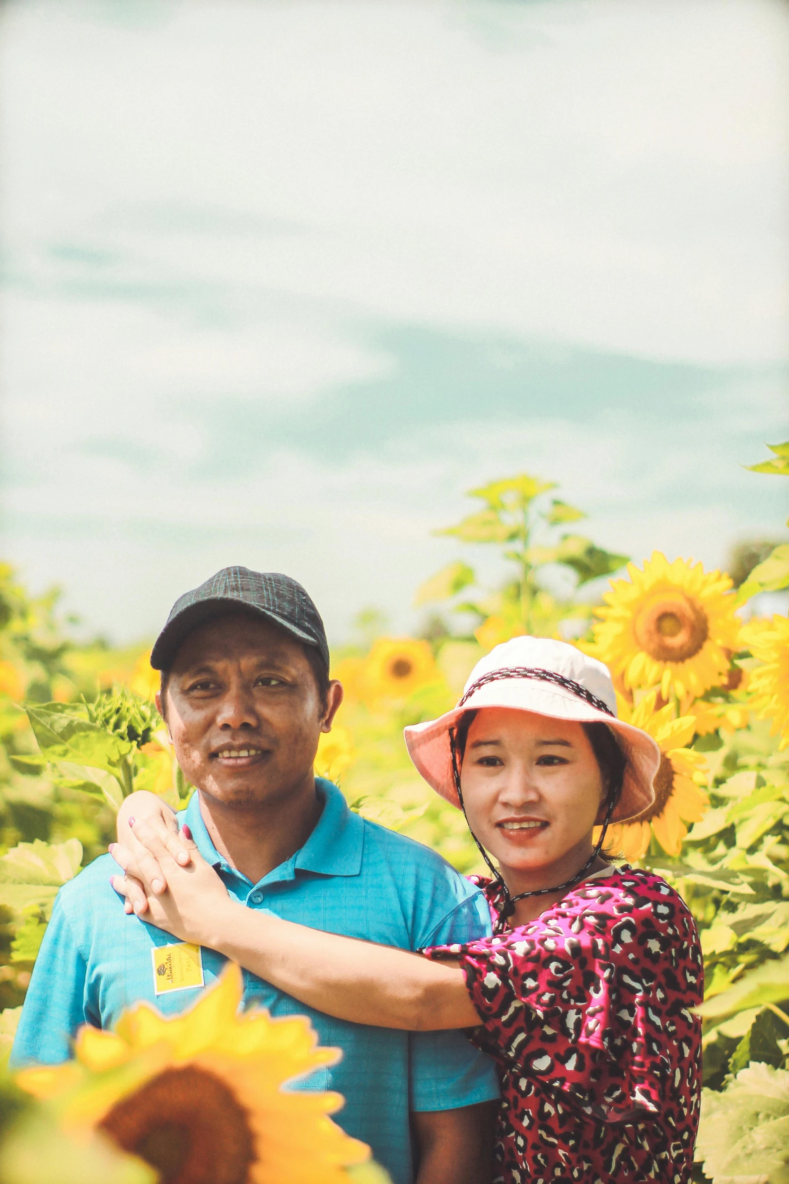 a man and a woman standing in a field of sunflowers, pexels contest winner, sumatraism, 2 5 6 x 2 5 6 pixels, an indonesian family portrait, 15081959 21121991 01012000 4k, myanmar