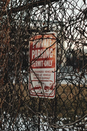 a sign on a fence that says private parking permit only, inspired by Elsa Bleda, trending on pexels, graffiti, ((rust)), 1990s photograph, horror themed, tiny