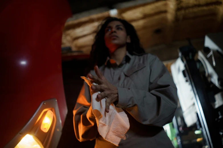 a woman standing next to a red fire hydrant, a portrait, unsplash, hurufiyya, serving fries, standing in a dimly lit room, ( ( theatrical ) ), low detail