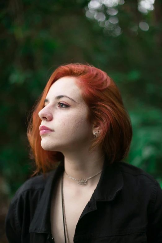 a woman with red hair wearing a black shirt, inspired by Elsa Bleda, trending on pexels, looking into the distance, color image, multiple stories, 1 6 years old