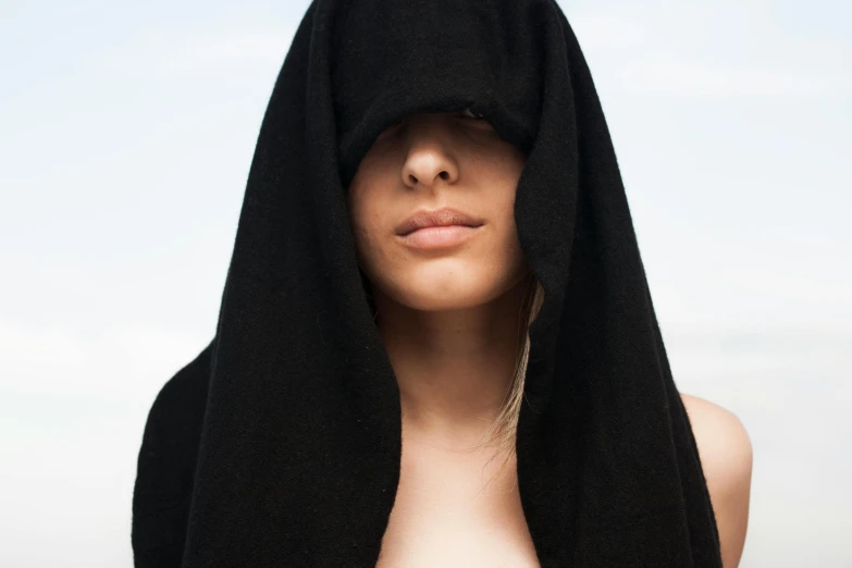 a woman with a black towel over her head, inspired by Hedi Xandt, unsplash, wearing cloak on blasted plain, slightly tanned, soft skin, demobaza