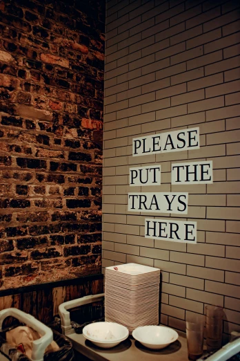 a brick wall with a sign that says please put the trays here, by Ian Hamilton Finlay, trending on unsplash, theater dressing room, instagram story, traps, philippe starck
