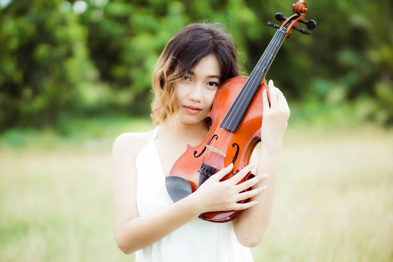 a woman holding a violin in a field, avatar image, asian women, portrait image