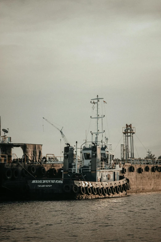 a boat that is sitting in the water, unsplash, graffiti, military carrier rig, low quality photo, industrial aesthetic, afar