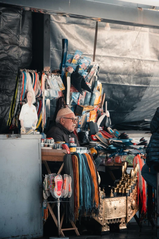 a couple of men standing next to each other, trending on unsplash, cloisonnism, market stalls, plastic and fabric, nepal, high light on the left