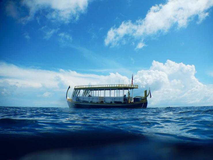 a boat floating in the middle of the ocean, at the bottom of the ocean, avatar image, in style of thawan duchanee, blue skies
