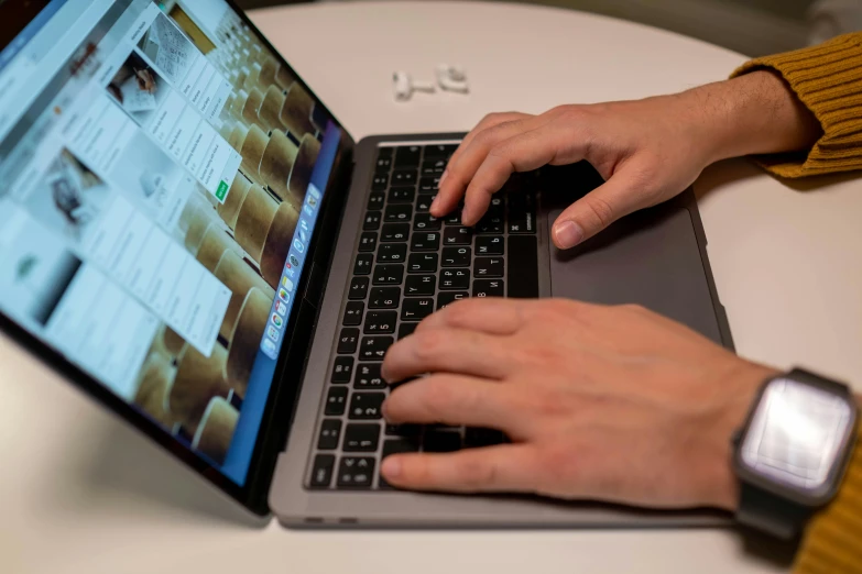 a close up of a person typing on a laptop, by Carey Morris, apple, the, technical, press