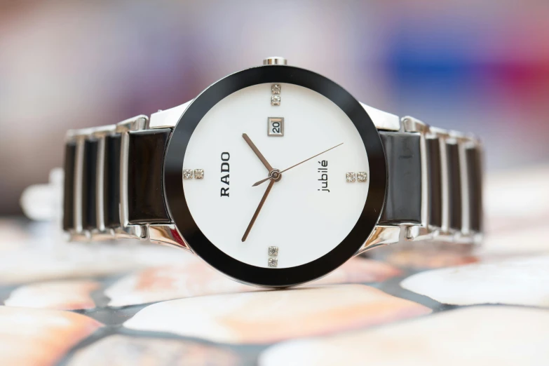 a close up of a wrist watch on a table, by Julia Pishtar, ratio, white gold black, date, thumbnail