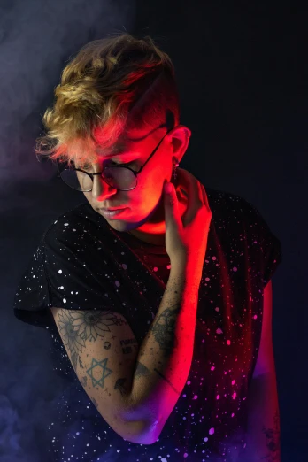 a man with a tattoo on his arm, an album cover, inspired by Elsa Bleda, pexels, holography, portrait androgynous girl, dazzling lights, wearing red tainted glasses, an epic non - binary model