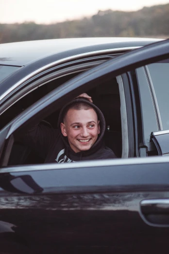 a man sitting in the drivers seat of a car, by Jacob Toorenvliet, happening, almost smiling, avatar image, mac miller, profile image