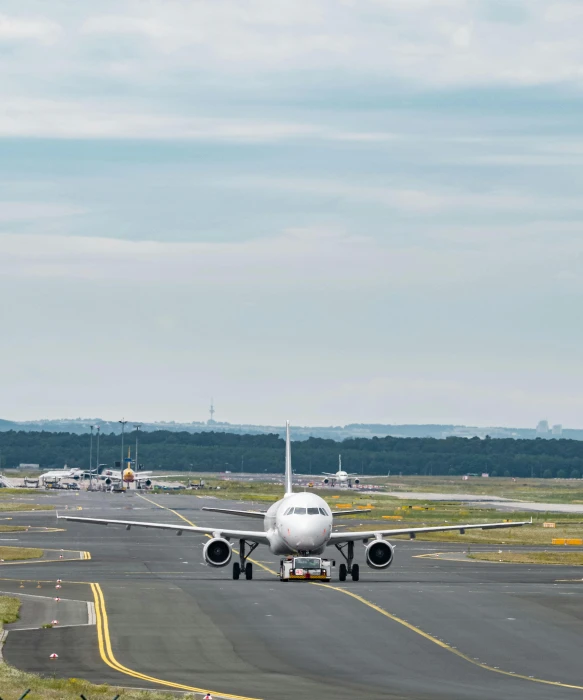 a large jetliner sitting on top of an airport runway, by Carey Morris, pexels contest winner, thumbnail, walking towards camera, airplanes, seen from a distance