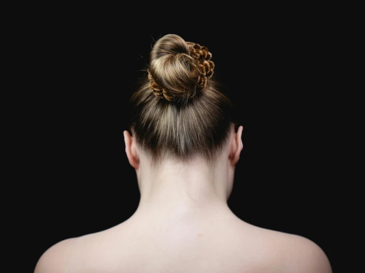 a woman with her back turned to the camera, unsplash, hair styled in a bun, with a black background, with a white complexion, only one head single portrait