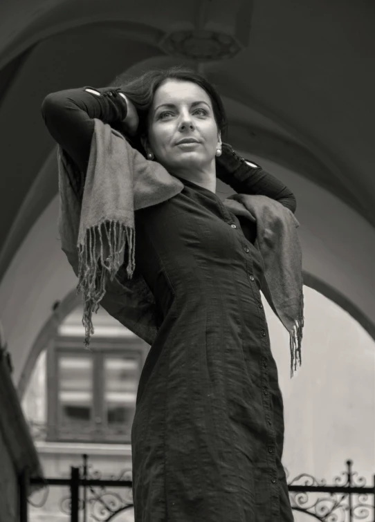 a black and white photo of a woman in a dress, inspired by Marina Abramović, pexels contest winner, arabesque, wrapped in a black scarf, casual pose, colours, as cristina kirchner