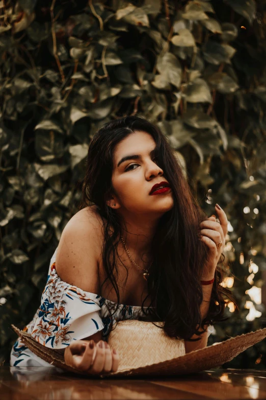 a woman laying on top of a wooden table, a picture, inspired by Elsa Bleda, trending on pexels, renaissance, indian girl with brown skin, thick red lips, sitting in a tree, pouting