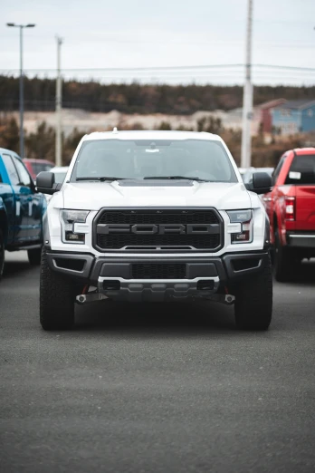 a white truck is parked in a parking lot, pexels contest winner, ford f-150 raptor, various colors, inside of an auto dealership, 15081959 21121991 01012000 4k