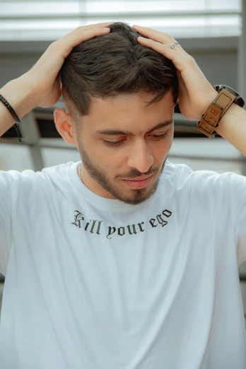a man sitting at a table with his hands on his head, inspired by Jean Malouel, trending on pexels, in tshirt, evil look, kilin eng, 2 2 years old