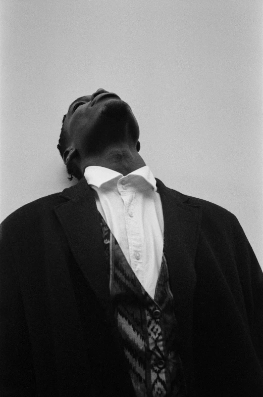 a black and white photo of a man in a suit, an album cover, by Carrie Mae Weems, unsplash, asleep, neck up, 1995, in the world of andrew wyeth