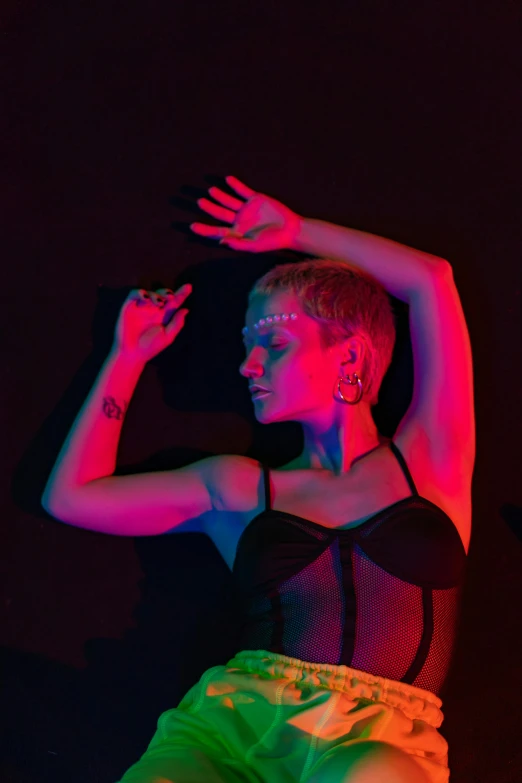 a woman in a black top and green shorts, an album cover, inspired by Elsa Bleda, pexels, holography, pixie cut with shaved side hair, high red lights, ibiza nightclub dancing inspired, infrared