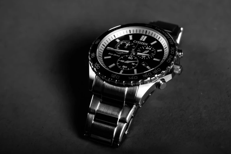 a close up of a watch on a table, a black and white photo, high detail product photo, f/stop, silver sports watch, titan