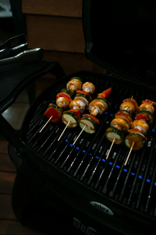 a close up of a grill with skewers on it, renaissance, multicolor, f / 3 2, dark vignette, lifestyle