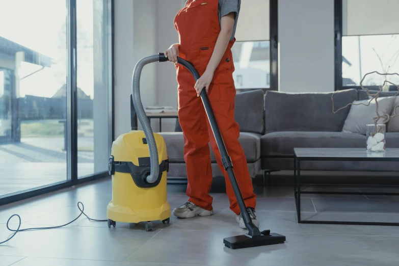 a man is cleaning a living room with a vacuum, a cartoon, pexels contest winner, hurufiyya, yellow overall, worksafe. cinematic, lady using yellow dress, profile photo