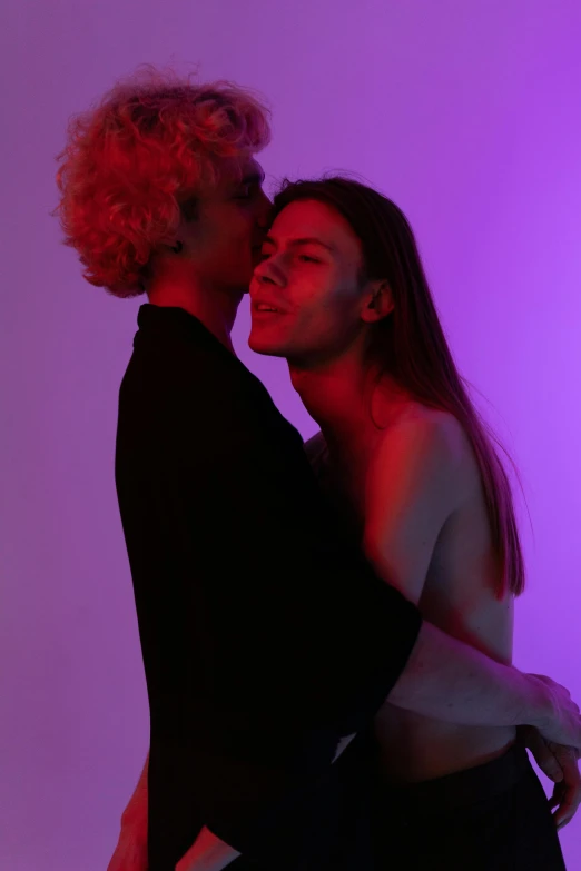 a man and a woman standing next to each other, inspired by Nan Goldin, antipodeans, purple scene lighting, lesbian embrace, promo image, studio photo