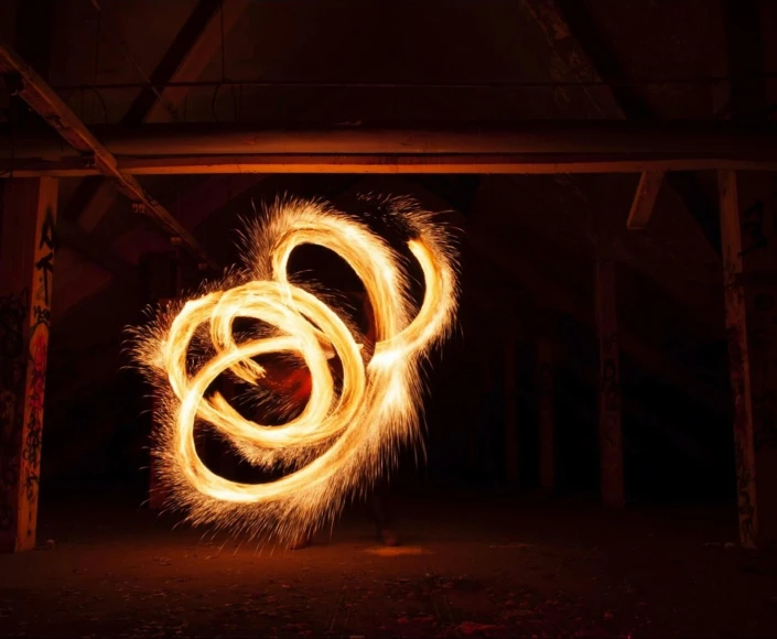 a fire spinning around in the dark, a stipple, pexels contest winner, kinetic art, orange halo, indoor picture, wall torches