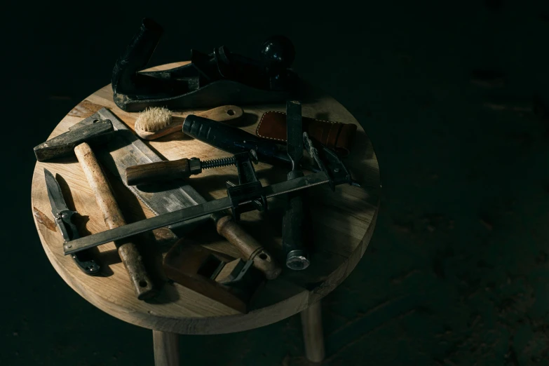 a pile of tools sitting on top of a wooden table, a still life, inspired by Constantin Hansen, pexels contest winner, assemblage, in a darkly lit laboratory room, furniture, slide show, restomod