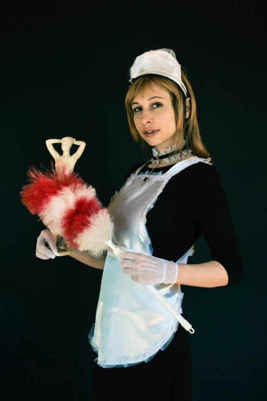 a woman dressed as a maid holding a broom, inspired by Leiko Ikemura, spider gwen, feather boa, portrait n - 9, wearing gloves