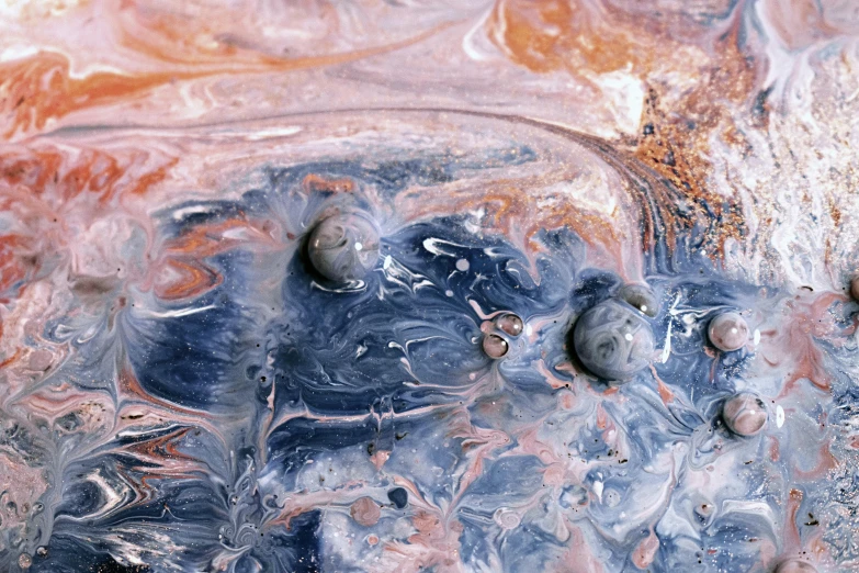 a close up of a mixture of liquid and rocks, trending on unsplash, space art, paint swirls and phyllotaxis, jupiter, grey, flying mud