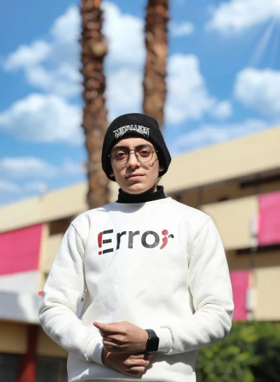 a man standing on a skateboard in front of a building, inspired by Farid Mansour, reddit, wearing correct era clothes, official store photo, tearing, eeri