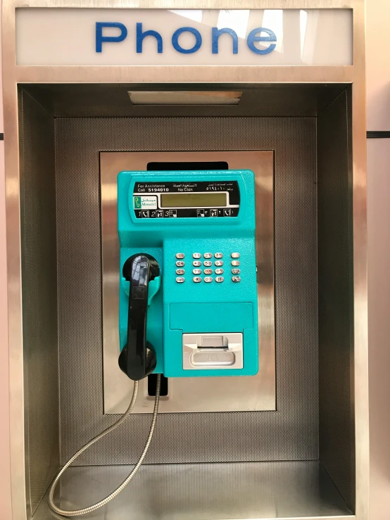 a blue pay phone sitting inside of a metal box, white and teal garment, control panel, 🌸 🌼 💮, open bank vault