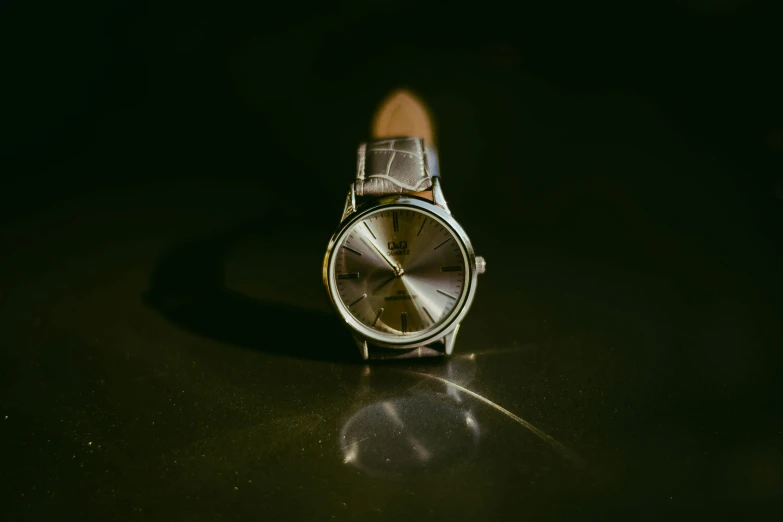 a close up of a watch on a table, pexels contest winner, hyperrealism, skin reflective metallic, ( low key light ), 2 0 5 0 s, patent leather