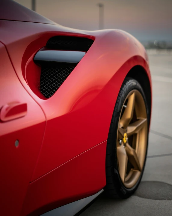 a red sports car parked in a parking lot, pexels contest winner, hyperrealism, red and golden color details, left profile, detailed-wheels, taken with sony alpha 9