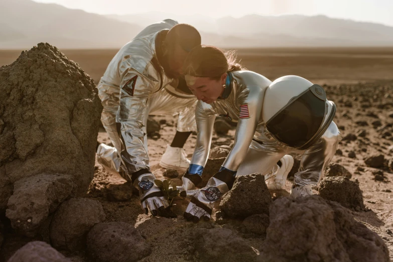 a couple of people that are in the dirt, unsplash, happening, realistic photo from nasa, skintight suits, planning, gemma chen