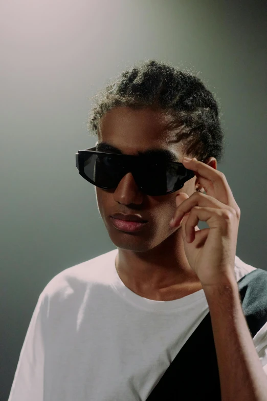 a woman holding a cell phone to her ear, an album cover, inspired by Antoine Wiertz, featured on reddit, photorealism, black teenage boy, wearing oakley sunglasses, imaan hammam, still from a music video