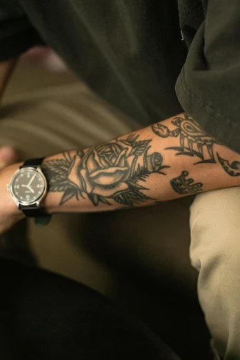 a close up of a person with a wrist tattoo, a tattoo, by Austin English, ap art, wears a watch, trending photo, rose tattoo
