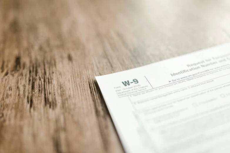 a piece of paper sitting on top of a wooden table, a picture