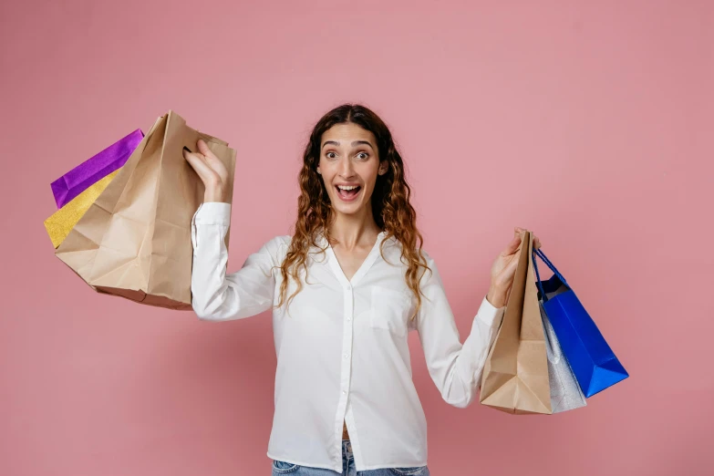 a woman in a white shirt holding shopping bags, pexels contest winner, all overly excited, brown and pink color scheme, avatar image, amazing beauty