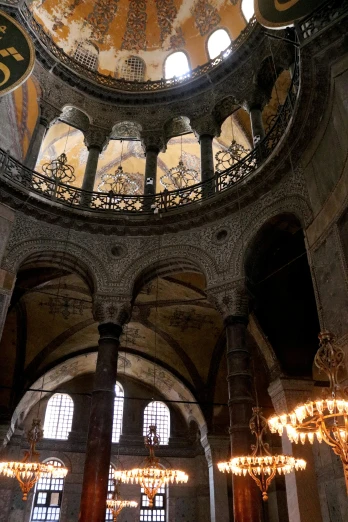 a dome in the middle of a building with chandeliers, inspired by Modest Urgell, romanesque, archs, turkey, grey, bl