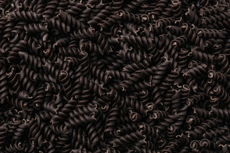 a pile of black curly hair sitting on top of a table, pasta, seamless micro detail, licorice allsort filling, ignant