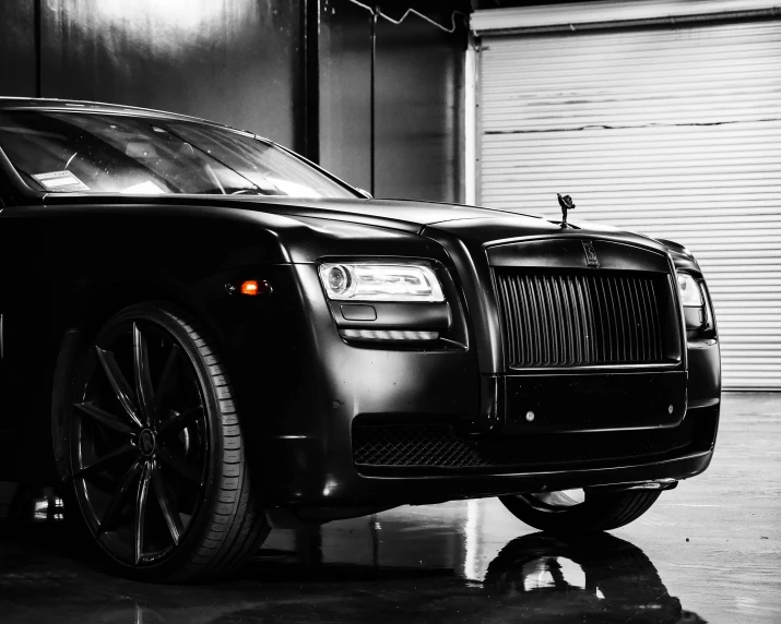 a black rolls royce parked in a garage, a black and white photo, unsplash, renaissance, square, all black matte product, 1, front