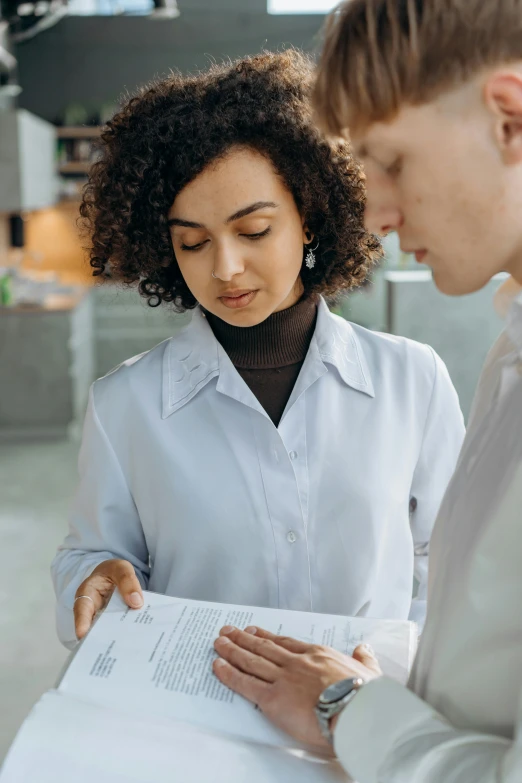 a man and a woman looking at a piece of paper, brown and white color scheme, medical reference, best practice, curated collections