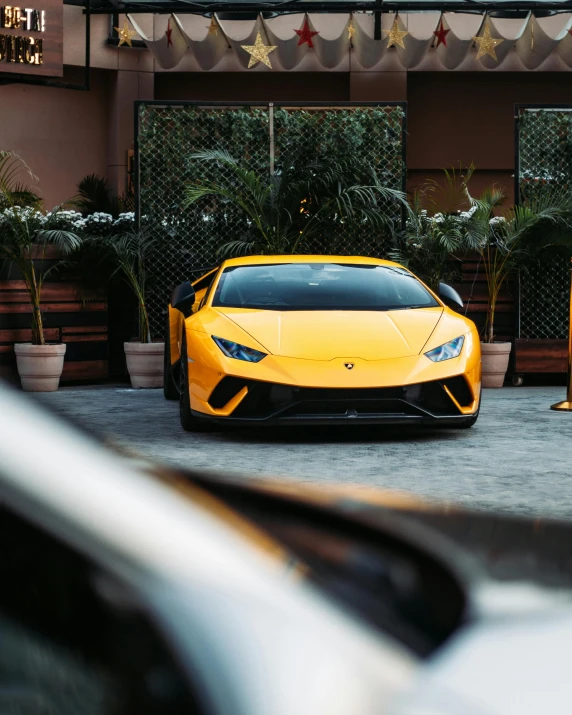 a yellow sports car parked in front of a building, top selection on unsplash, lamborghini, cute boys, instagram photo