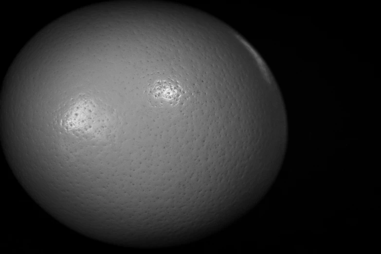 an egg sitting on top of a black surface, by Jan Rustem, featured on zbrush central, kinetic pointillism, taken through a telescope, ice planet, smooth porcelain skin, close-up shot taken from behind