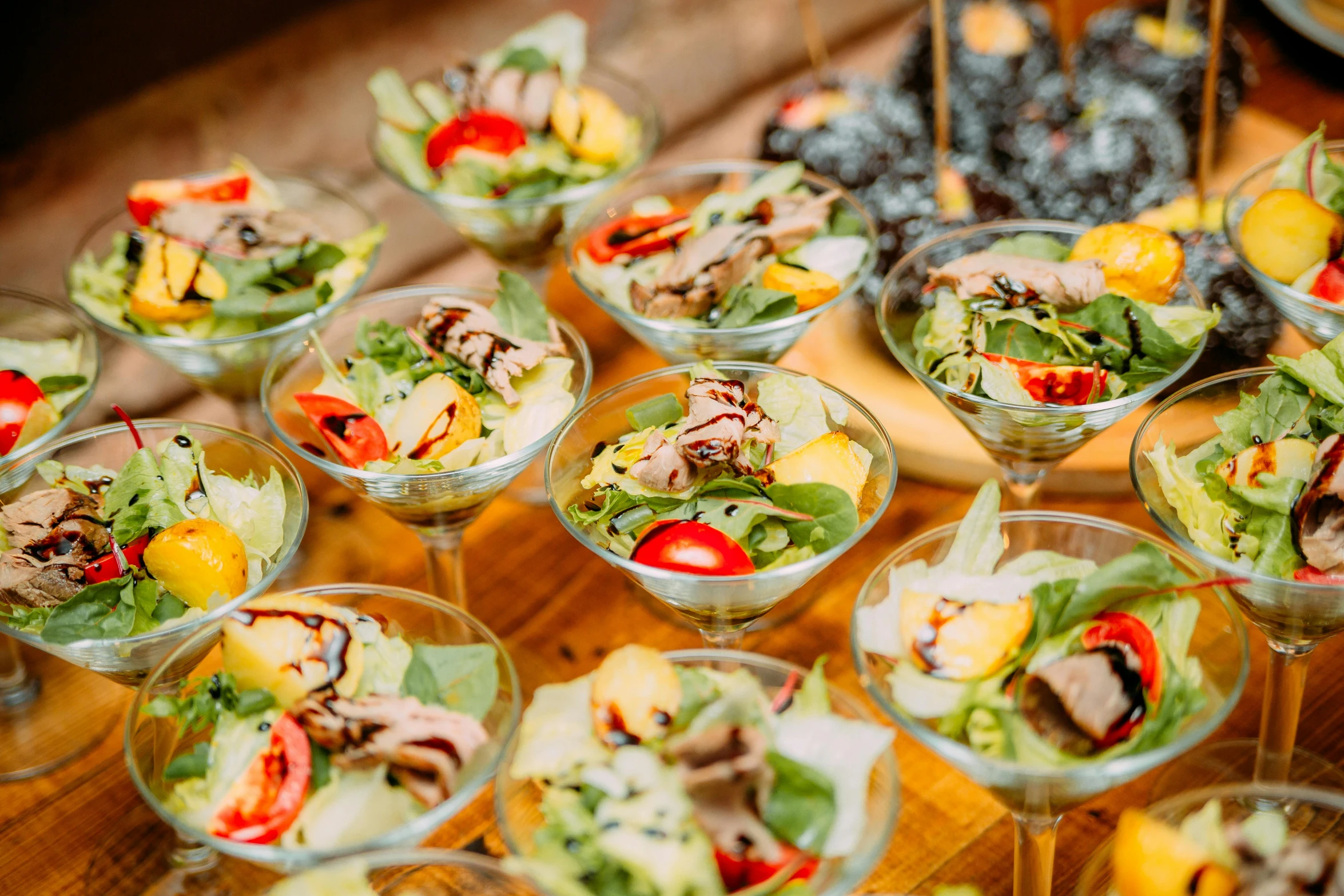 a wooden table topped with glasses filled with food, by Julia Pishtar, pexels, salad, wedding, 6 pack, sea of parfait