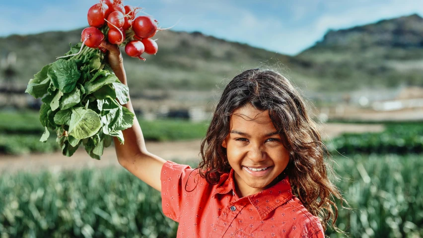 a young girl holding up a bunch of radishes, by Daniel Schultz, pexels contest winner, imaan hammam, avatar image, on a farm, isabela moner