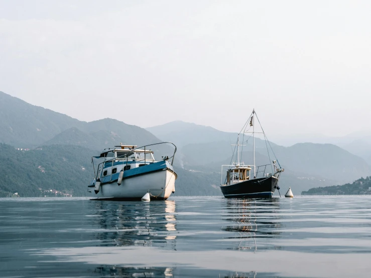 a couple of boats floating on top of a body of water, by Carey Morris, pexels contest winner, modernism, picton blue, hong kong, jovana rikalo, carson ellis